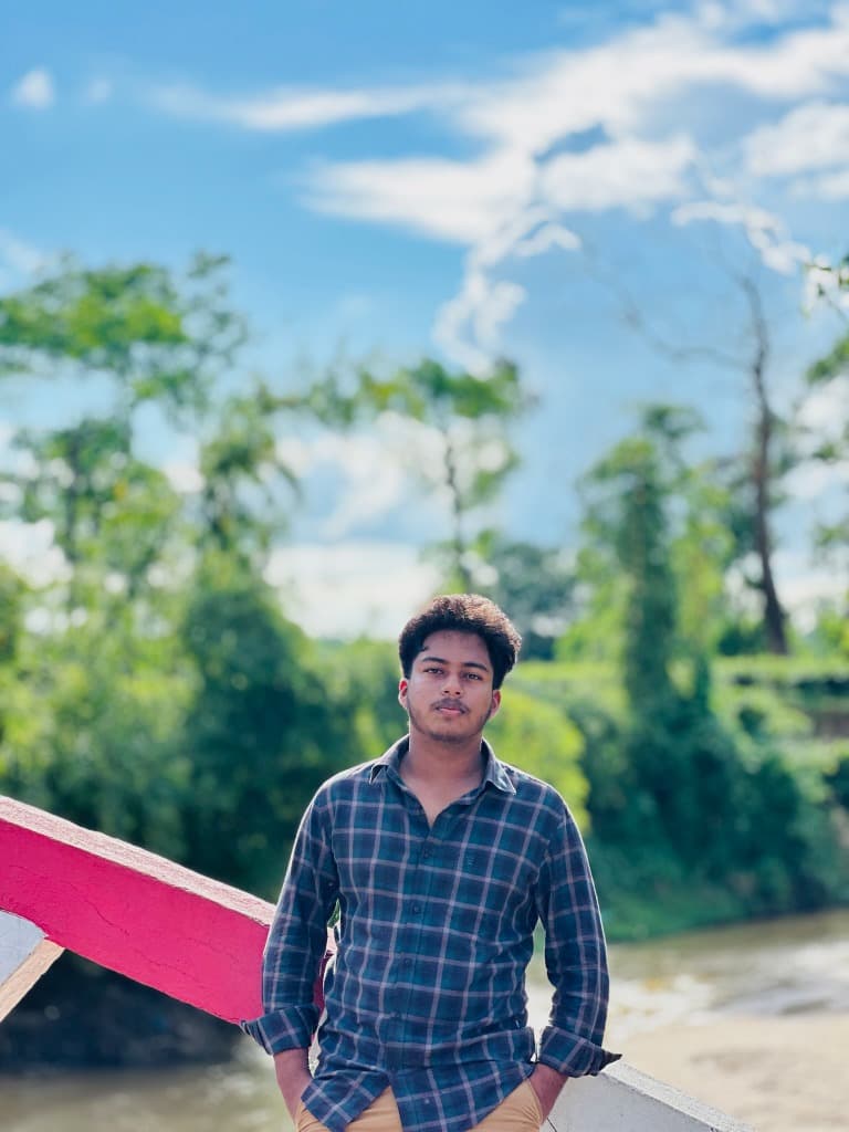Kazi Samiul Haque Adrik sitting on a bench in a green park